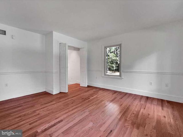 spare room featuring wood-type flooring