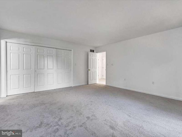 unfurnished bedroom featuring a closet and carpet