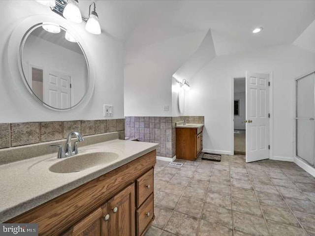 bathroom featuring vanity, vaulted ceiling, and tile patterned floors