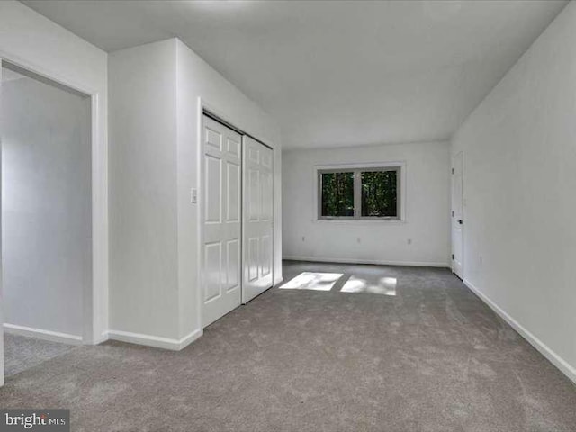 unfurnished bedroom featuring a closet and carpet flooring