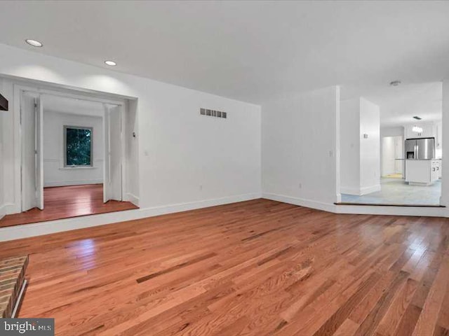 unfurnished living room with hardwood / wood-style floors