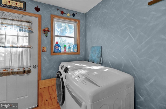 clothes washing area with independent washer and dryer