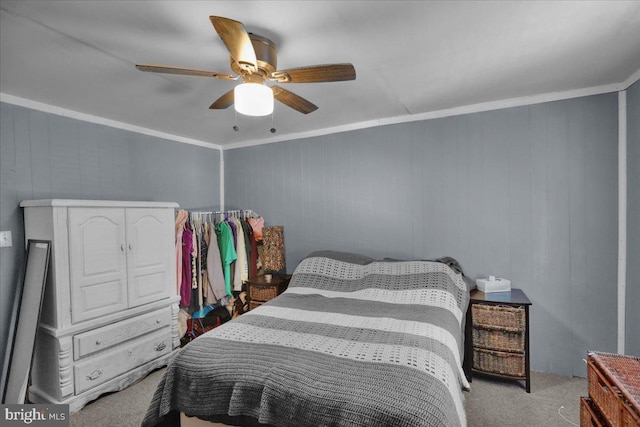 carpeted bedroom with ornamental molding and ceiling fan