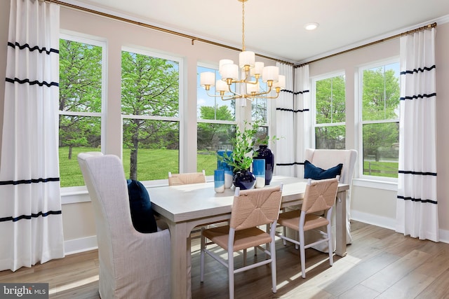 dining space featuring a wealth of natural light, a chandelier, and light hardwood / wood-style floors