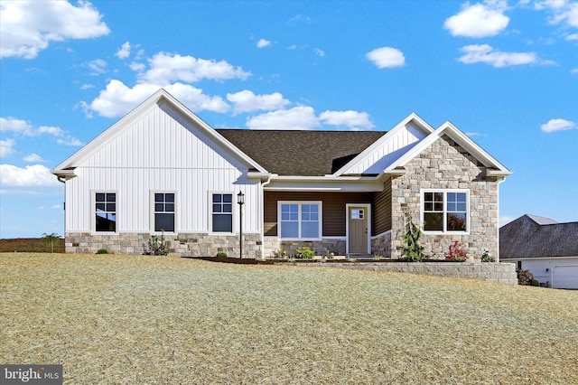 view of front of home with a front yard and a garage