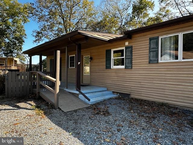 view of exterior entry featuring a porch