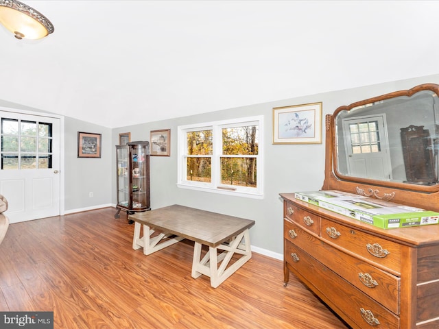 interior space with light hardwood / wood-style floors and lofted ceiling