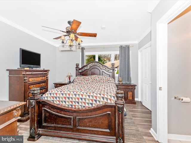 bedroom featuring wood-type flooring, ceiling fan, crown molding, and a wall mounted air conditioner