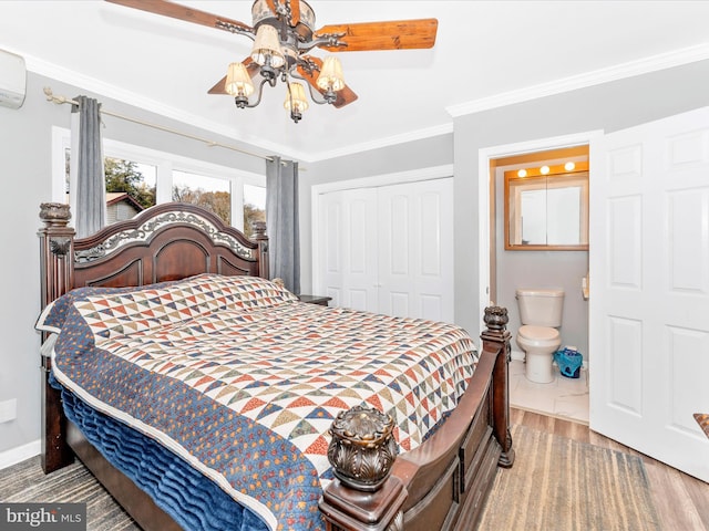 bedroom featuring hardwood / wood-style flooring, ornamental molding, ensuite bathroom, ceiling fan, and a closet