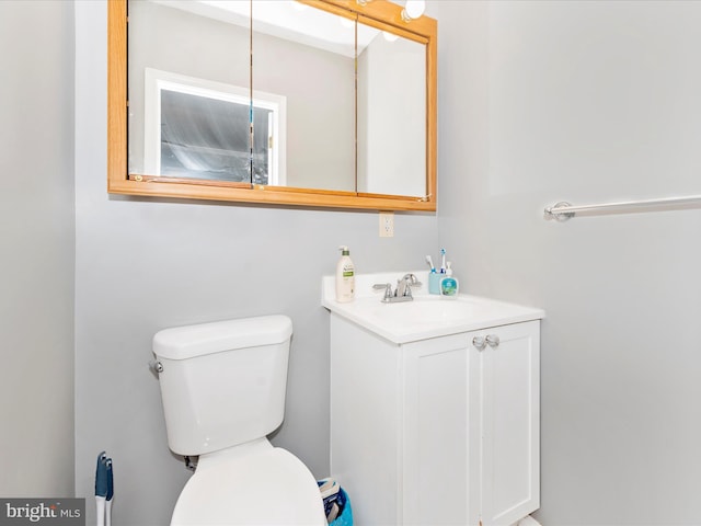 bathroom featuring toilet and vanity