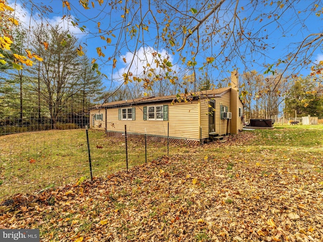 view of side of property with a lawn