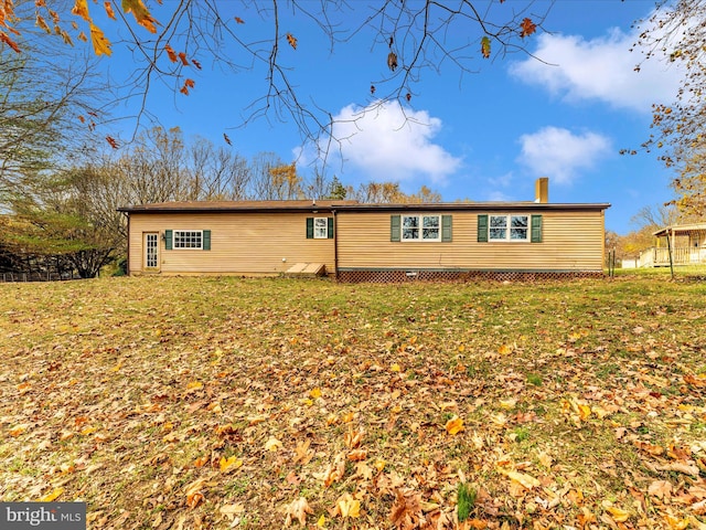 rear view of house with a yard