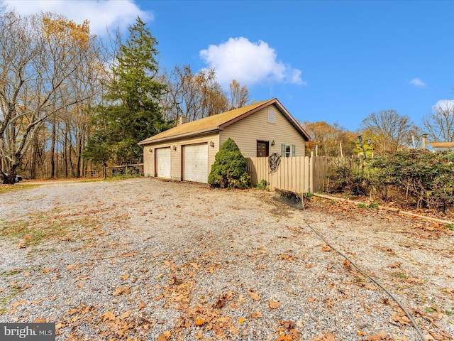 view of side of home with an outbuilding and a garage