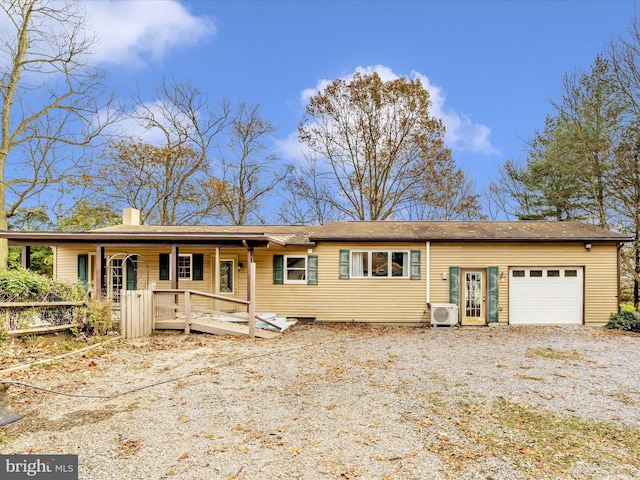 view of front of home with a garage and ac unit