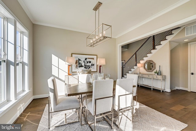 dining room featuring stairs, visible vents, dark wood finished floors, and a healthy amount of sunlight
