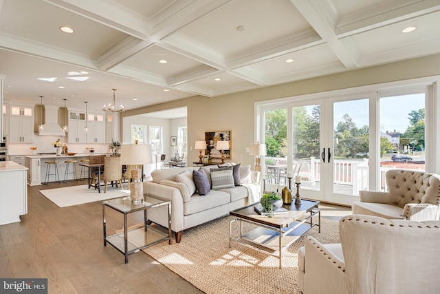 living room with beam ceiling, coffered ceiling, and wood-type flooring