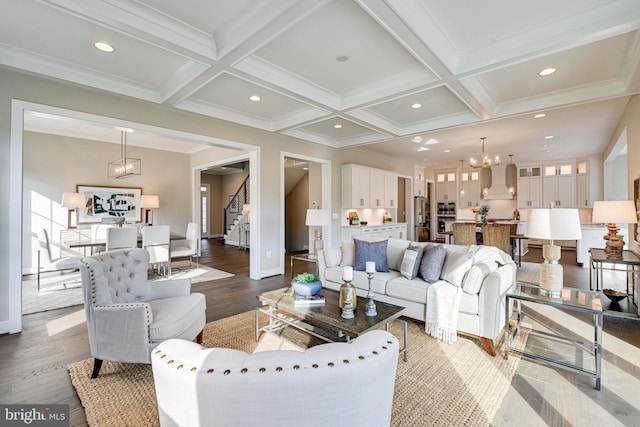 living room featuring coffered ceiling, wood-type flooring, and beamed ceiling