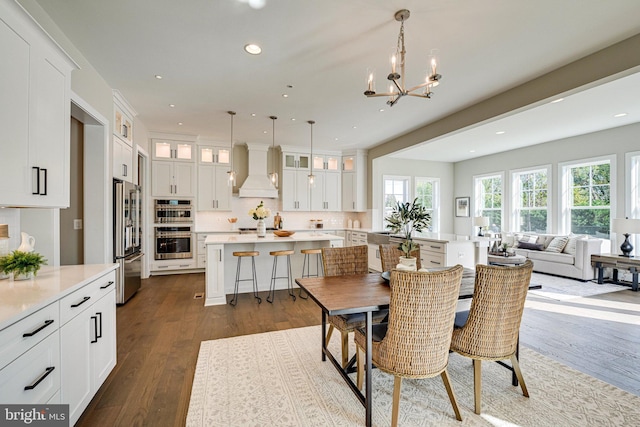 dining room featuring a notable chandelier and dark hardwood / wood-style flooring