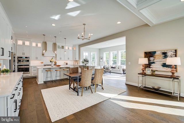 dining space featuring an inviting chandelier, baseboards, recessed lighting, and dark wood-type flooring