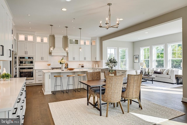 dining space featuring an inviting chandelier and dark wood-type flooring