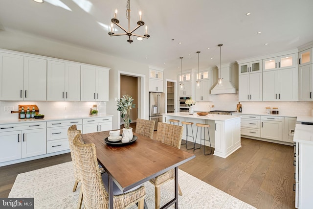 dining area featuring an inviting chandelier and dark hardwood / wood-style floors