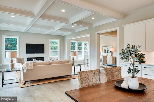 dining room featuring beam ceiling, coffered ceiling, and light wood-type flooring