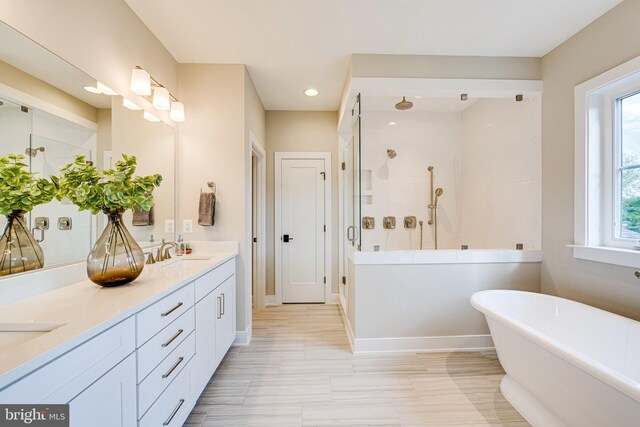 bathroom with vanity and independent shower and bath