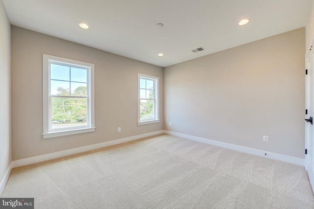 empty room with light colored carpet