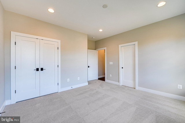 unfurnished bedroom with light carpet