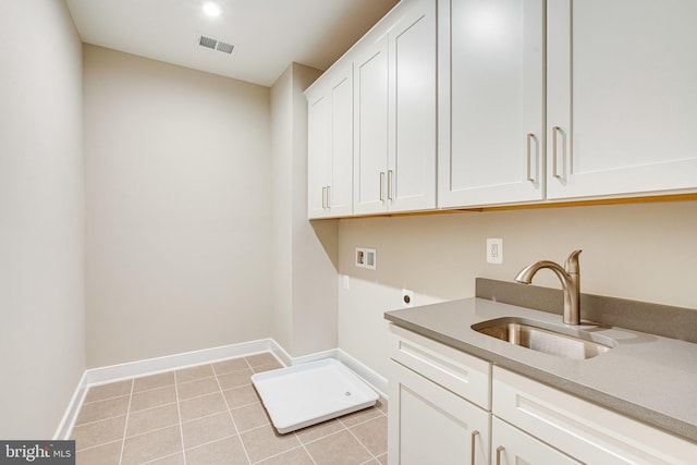 laundry area with cabinets, washer hookup, light tile patterned flooring, hookup for an electric dryer, and sink