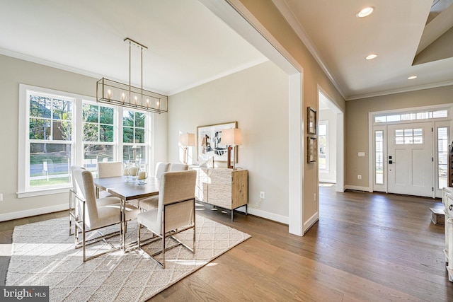 dining space featuring crown molding and hardwood / wood-style flooring