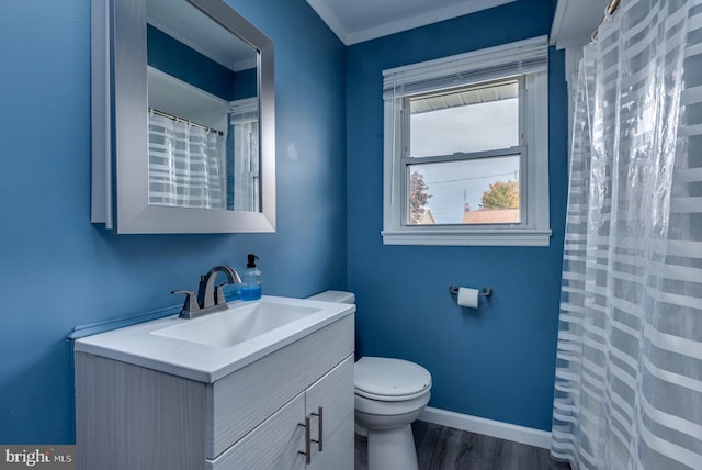 bathroom with vanity, toilet, ornamental molding, and hardwood / wood-style floors