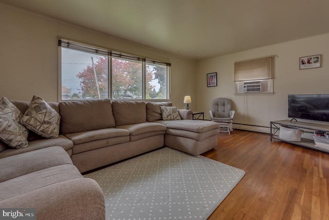 living room featuring hardwood / wood-style floors, a baseboard heating unit, and cooling unit