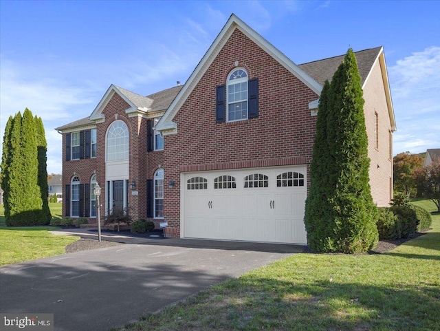 view of front of home featuring a garage and a front lawn