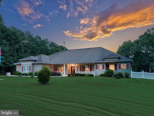 ranch-style home featuring a yard and a porch