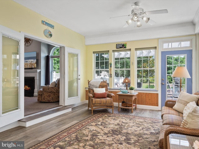 sunroom / solarium featuring ceiling fan