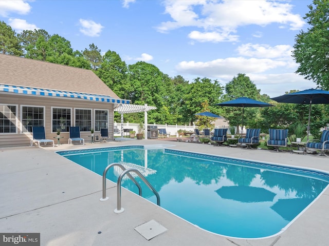 view of swimming pool with a patio area and a pergola