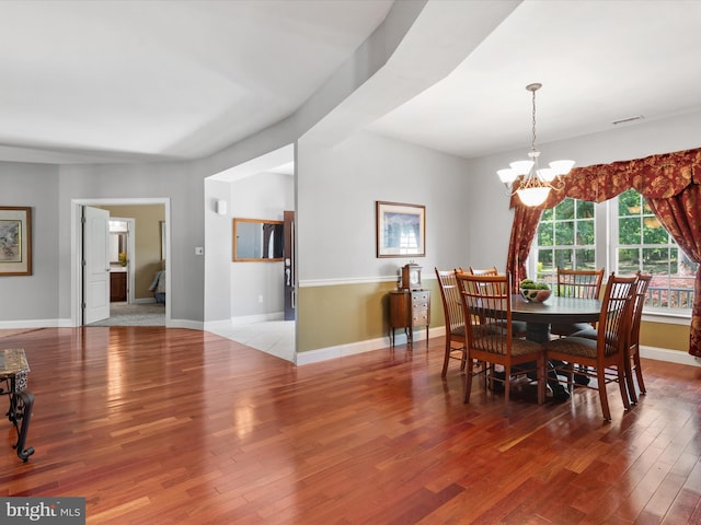 dining room featuring hardwood / wood-style flooring and a chandelier