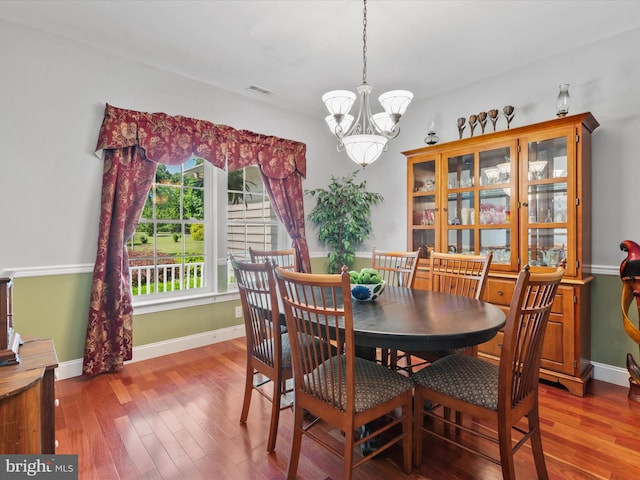 dining space with a chandelier and hardwood / wood-style flooring