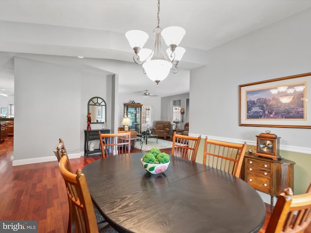 dining area with a notable chandelier and dark hardwood / wood-style floors