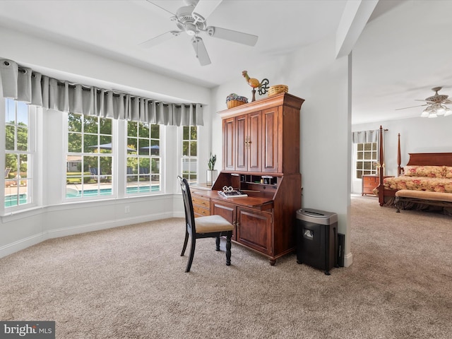 carpeted home office with ceiling fan