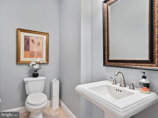 bathroom featuring sink, toilet, and tile patterned flooring