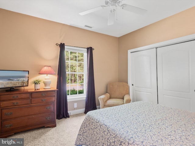 carpeted bedroom featuring a closet and ceiling fan