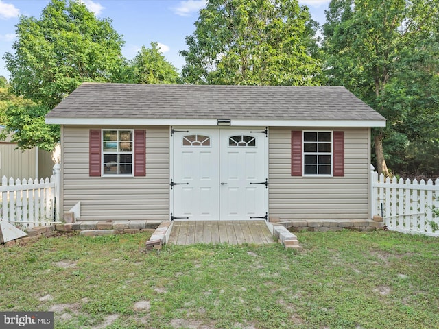 view of outbuilding with a yard