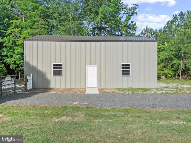 view of outbuilding with a yard