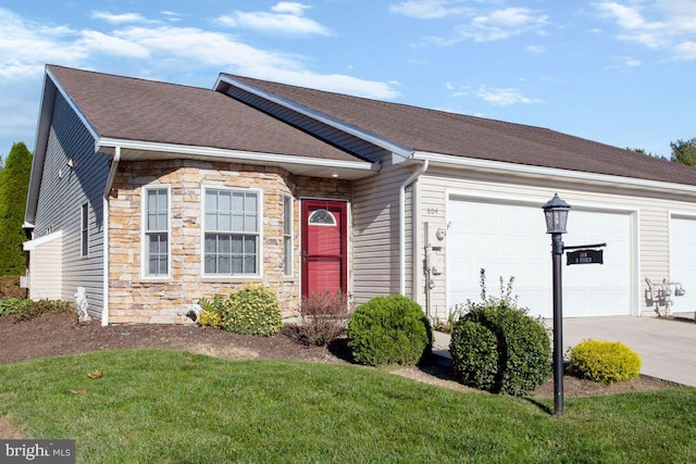 single story home with a garage and a front lawn