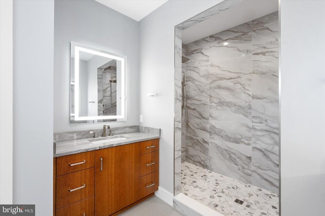 bathroom featuring vanity and tiled shower