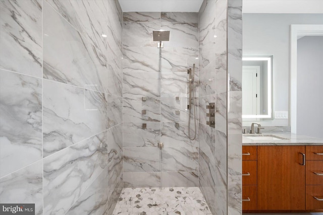 bathroom with vanity and tiled shower