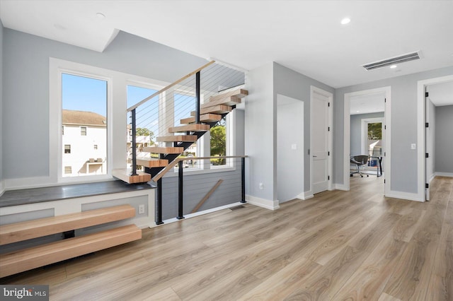 staircase with hardwood / wood-style flooring