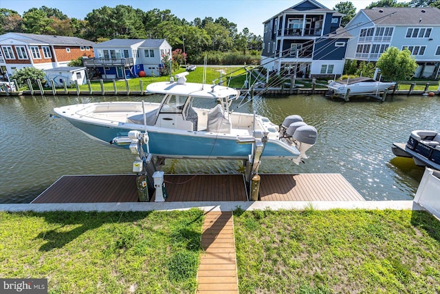 dock area with a lawn and a water view